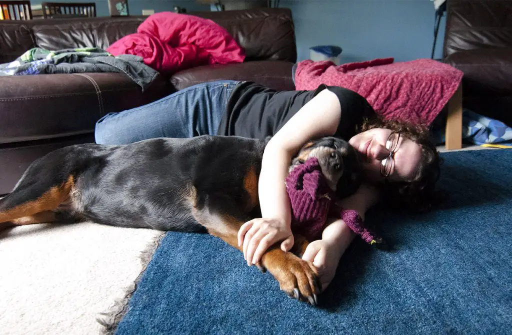WOMAN LAID DOWN WITH A ROTTWEILER